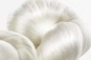A bundle of beautiful silk glows from the centre on a white background.