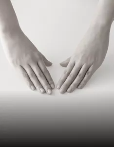 Two hands positioned palm down, prepared to start a skincare routine